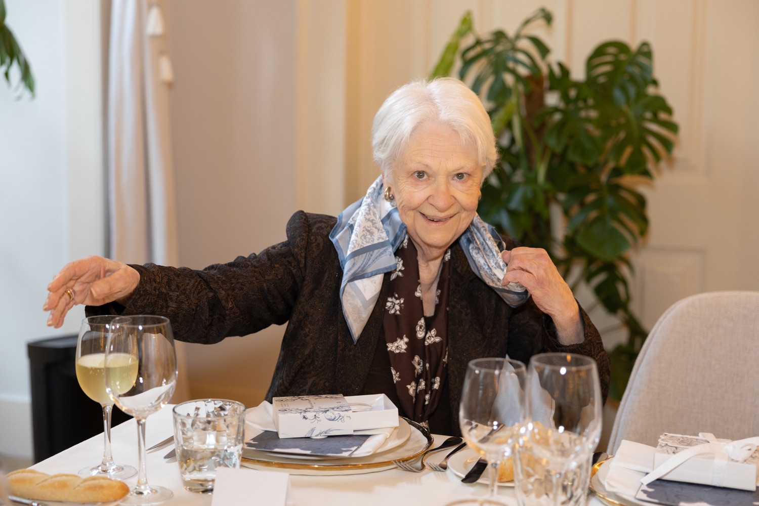 A guest at a delivered wedding, wearing her scarf at the table